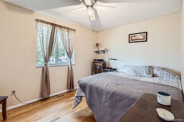3512 E 117th Pl, Thornton, CO 80233 - bedroom featuring wood finished floors, baseboards, a textured ceiling, and ceiling fan