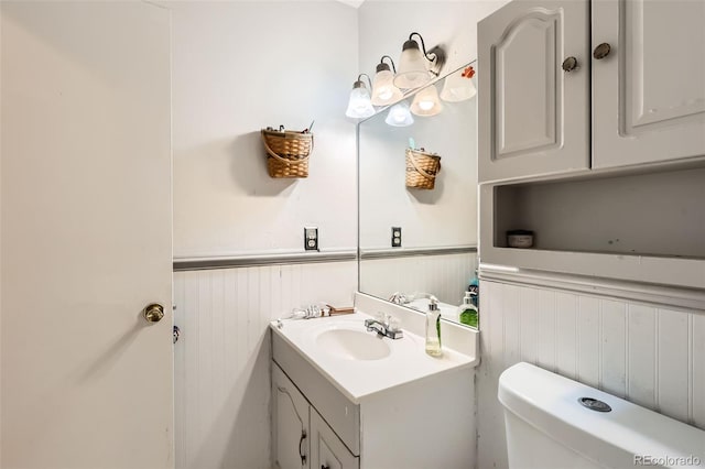 3512 E 117th Pl, Thornton, CO 80233 - half bathroom with wainscoting, vanity, and toilet