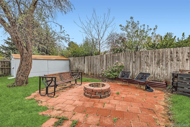3512 E 117th Pl, Thornton, CO 80233 - view of patio featuring a fire pit, a storage shed, and an outbuilding