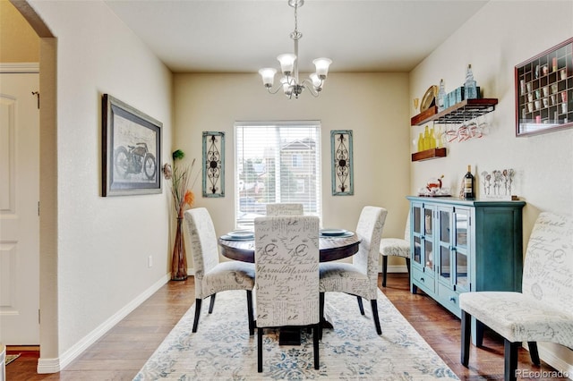 9046 Sandpiper Dr, Frederick, CO 80504 - dining room with a chandelier, wood finished floors, and baseboards