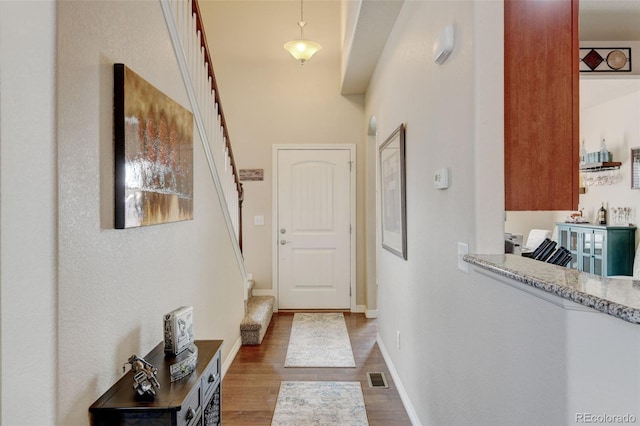 9046 Sandpiper Dr, Frederick, CO 80504 - doorway featuring stairway, wood finished floors, and baseboards