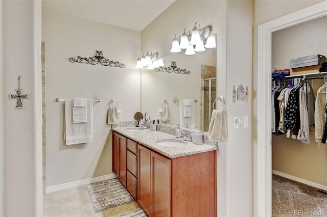 9046 Sandpiper Dr, Frederick, CO 80504 - full bathroom featuring a spacious closet, a shower stall, double vanity, and baseboards