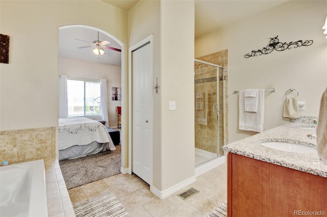 9046 Sandpiper Dr, Frederick, CO 80504 - ensuite bathroom with a stall shower, tile patterned floors, and ceiling fan