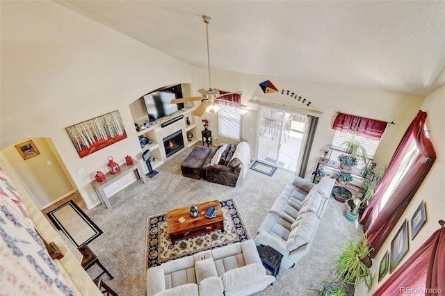9046 Sandpiper Dr, Frederick, CO 80504 - living room featuring carpet floors, a ceiling fan, a tile fireplace, and high vaulted ceiling