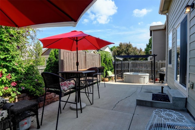 9046 Sandpiper Dr, Frederick, CO 80504 - fenced backyard featuring a patio area, outdoor dining area, area for grilling, and a hot tub