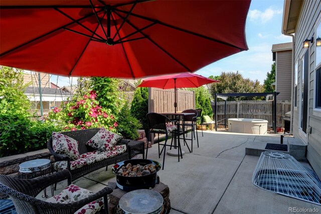 9046 Sandpiper Dr, Frederick, CO 80504 - fenced backyard featuring a patio area, an outdoor living space with a fire pit, a hot tub, and outdoor dining area
