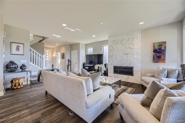 living room featuring a fireplace and dark hardwood / wood-style floors