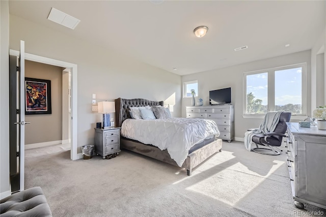 carpeted bedroom with multiple windows