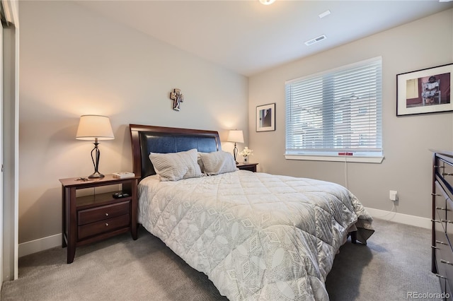 bedroom featuring light carpet