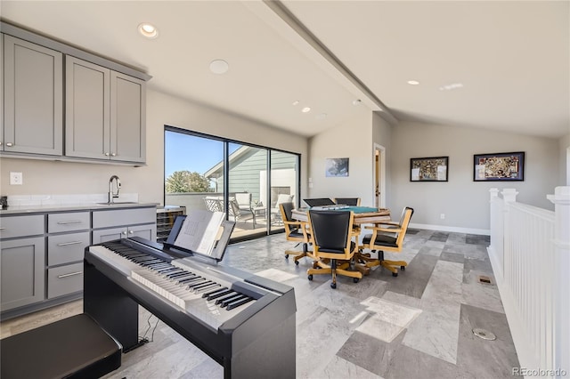 dining room featuring sink and vaulted ceiling