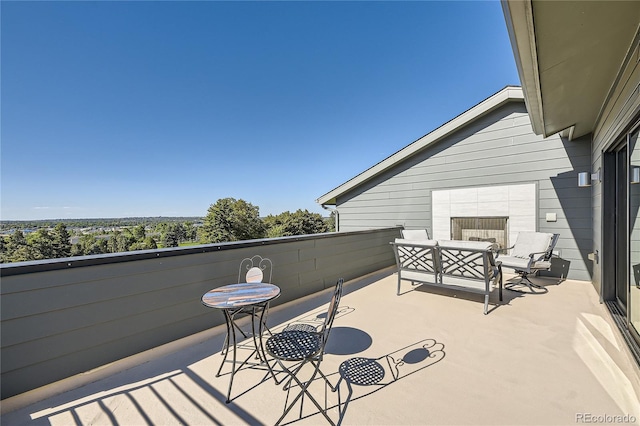 view of patio featuring an outdoor hangout area and a balcony