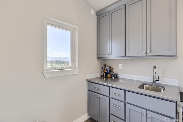 interior space with gray cabinets and sink