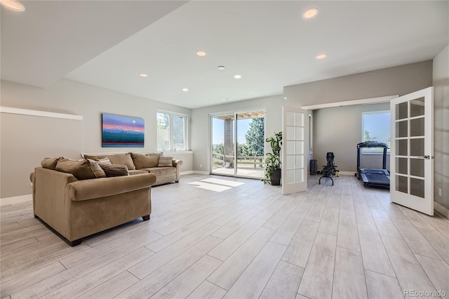 living room with french doors and light hardwood / wood-style flooring