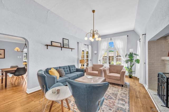 1300 Cherry St, Denver, CO 80220 - living room with light wood-type flooring, a chandelier, lofted ceiling, baseboards, and a textured wall