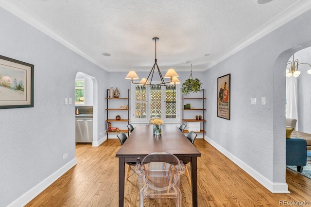 1300 Cherry St, Denver, CO 80220 - dining room with arched walkways, a chandelier, light wood-style floors, ornamental molding, and a textured wall