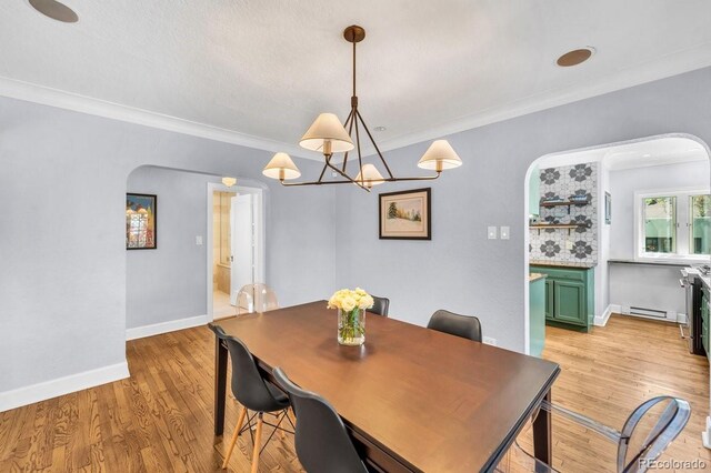 1300 Cherry St, Denver, CO 80220 - dining area featuring arched walkways, ornamental molding, baseboards, light wood-type flooring, and baseboard heating