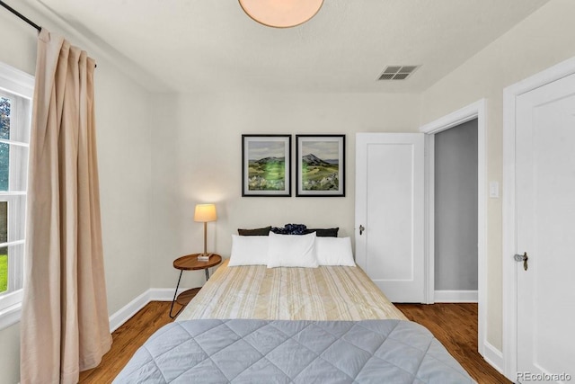 1300 Cherry St, Denver, CO 80220 - bedroom with wood finished floors, multiple windows, and baseboards