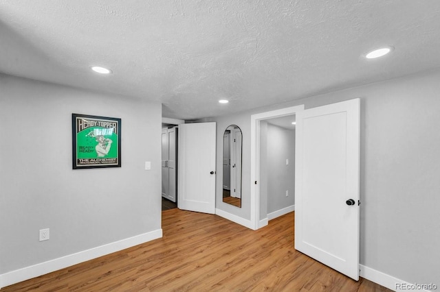 1300 Cherry St, Denver, CO 80220 - empty room featuring light wood-style floors, baseboards, recessed lighting, and a textured ceiling