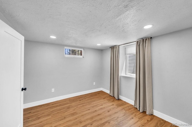 1300 Cherry St, Denver, CO 80220 - spare room featuring a textured ceiling, light wood-style flooring, baseboards, and recessed lighting