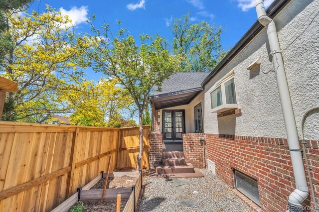 1300 Cherry St, Denver, CO 80220 - fenced backyard featuring french doors and a vegetable garden