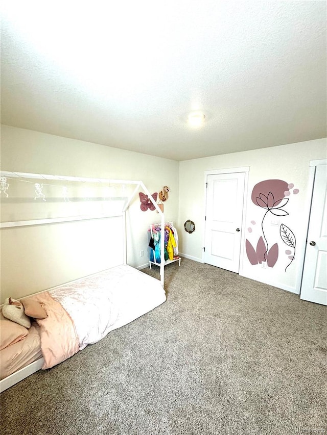 unfurnished bedroom with a textured ceiling and carpet flooring