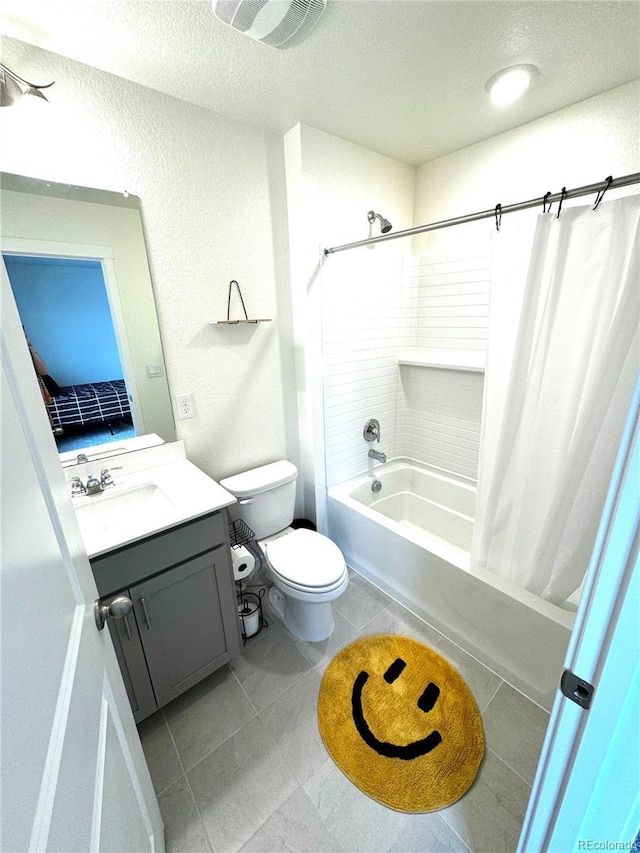 bathroom with shower / tub combo with curtain, toilet, vanity, a textured ceiling, and tile patterned floors