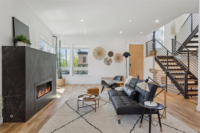 1801 W 33rd Ave, Denver, CO 80211 - living room with wood finished floors, stairs, a glass covered fireplace, and recessed lighting