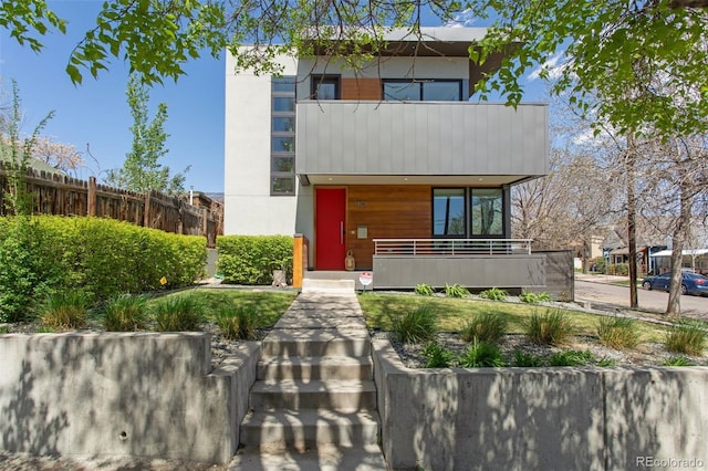 1801 W 33rd Ave, Denver, CO 80211 - contemporary house with a balcony, covered porch, and stucco siding