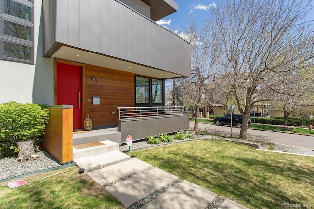 1801 W 33rd Ave, Denver, CO 80211 - view of exterior entry featuring a porch and a lawn