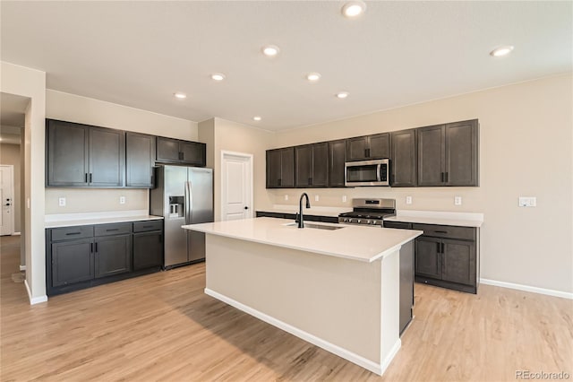 4114 Estrella St, Brighton, CO 80601 - kitchen with stainless steel appliances, light wood-style flooring, light countertops, a kitchen island with sink, and recessed lighting