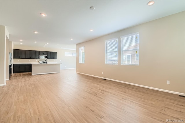 4114 Estrella St, Brighton, CO 80601 - unfurnished living room featuring light wood-style flooring and recessed lighting