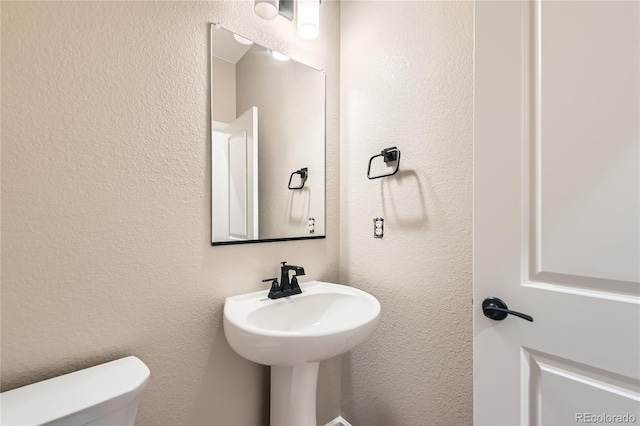 4114 Estrella St, Brighton, CO 80601 - bathroom featuring toilet and a textured wall