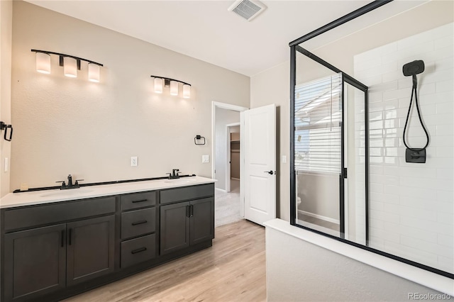 4114 Estrella St, Brighton, CO 80601 - bathroom featuring a stall shower, wood finished floors, and double vanity