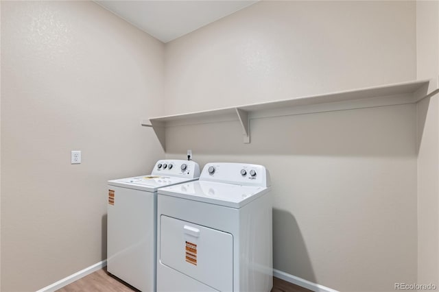 4114 Estrella St, Brighton, CO 80601 - laundry area with separate washer and dryer and light wood-style floors