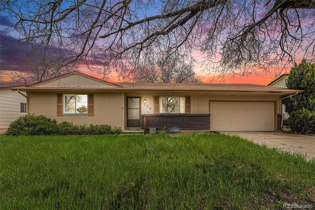 726 Mobile St, Aurora, CO 80011 - ranch-style house featuring an attached garage, driveway, and a lawn