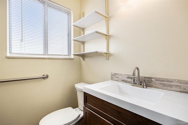 726 Mobile St, Aurora, CO 80011 - half bathroom featuring tasteful backsplash, toilet, and vanity