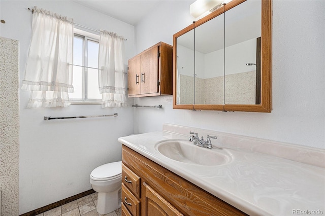 726 Mobile St, Aurora, CO 80011 - bathroom with vanity, toilet, and baseboards