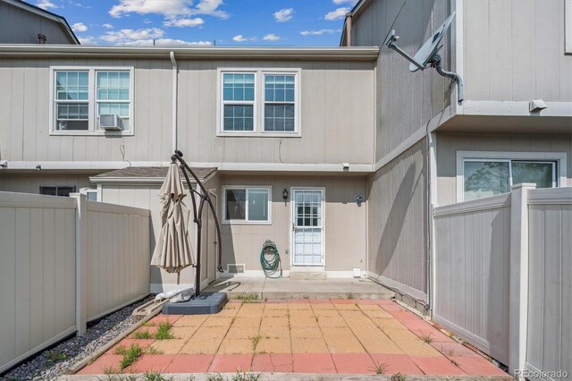 9679 W Chatfield Ave Unit C, Littleton, CO 80128 - rear view of property featuring a patio and cooling unit