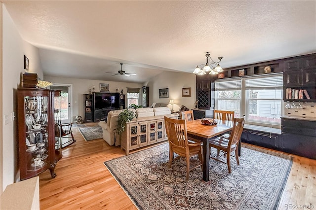 13642 Wrangler Way, Mead, CO 80542 - dining room with a chandelier, light wood finished floors, plenty of natural light, a textured ceiling, and a ceiling fan