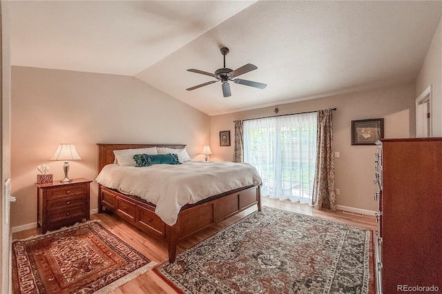 13642 Wrangler Way, Mead, CO 80542 - bedroom featuring access to outside, light wood-style flooring, vaulted ceiling, and a ceiling fan