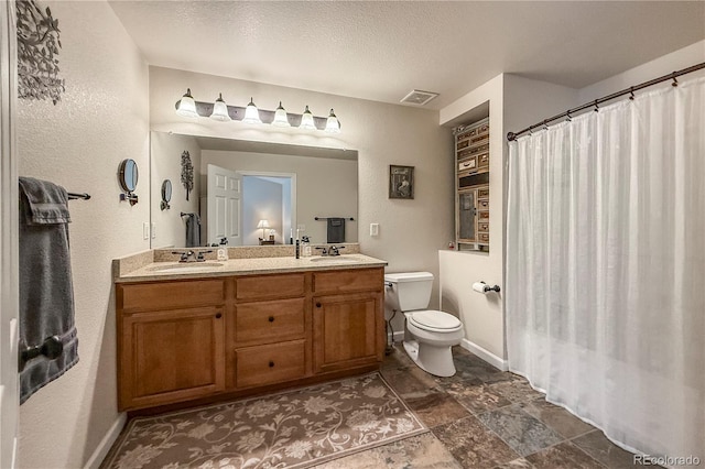 13642 Wrangler Way, Mead, CO 80542 - full bath with double vanity, a textured wall, and a textured ceiling