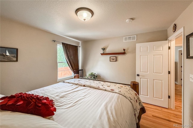 13642 Wrangler Way, Mead, CO 80542 - bedroom featuring light wood-type flooring and a textured ceiling