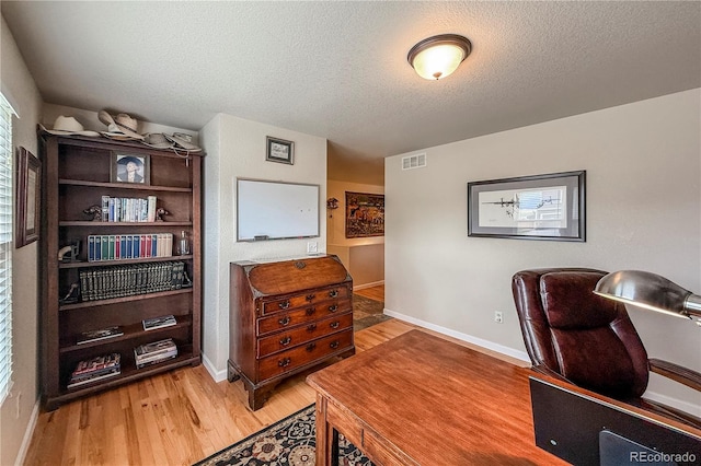 13642 Wrangler Way, Mead, CO 80542 - home office featuring light wood-style flooring and a textured ceiling