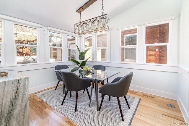 sunroom featuring vaulted ceiling and visible vents