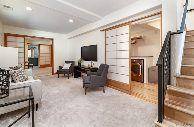 carpeted living room with washer / dryer, stairway, visible vents, and recessed lighting