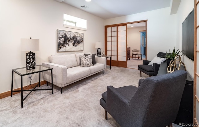 living room with baseboards, french doors, visible vents, and light colored carpet