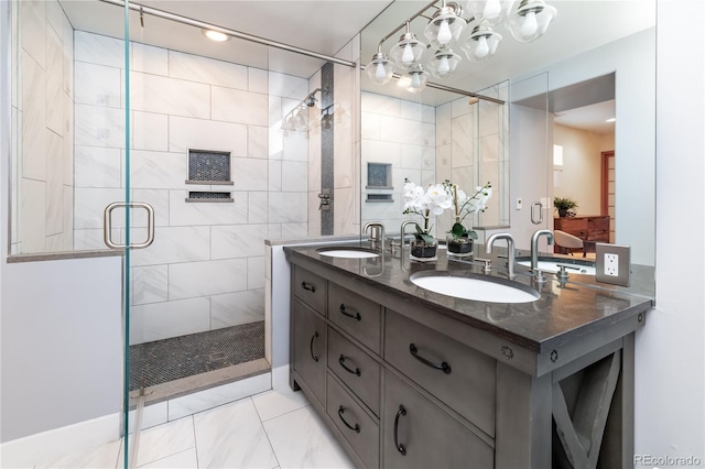 bathroom with double vanity, a stall shower, and a sink