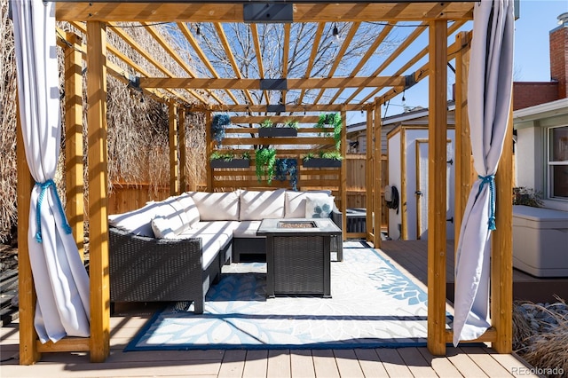 view of patio with an outdoor living space with a fire pit, an outbuilding, a storage unit, a wooden deck, and a pergola