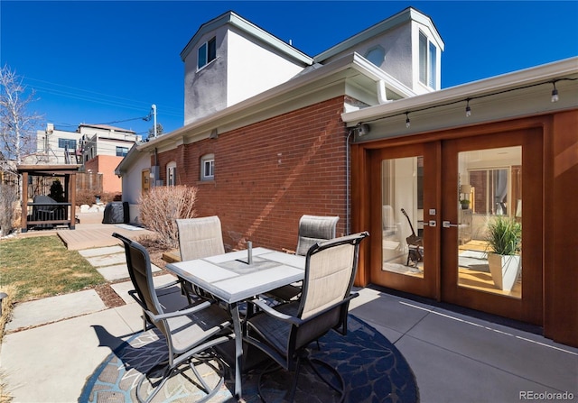 view of patio with outdoor dining space and french doors