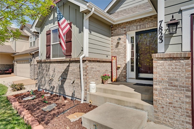7823 E 130th Pl, Thornton, CO 80602 - view of exterior entry with a garage, driveway, and brick siding